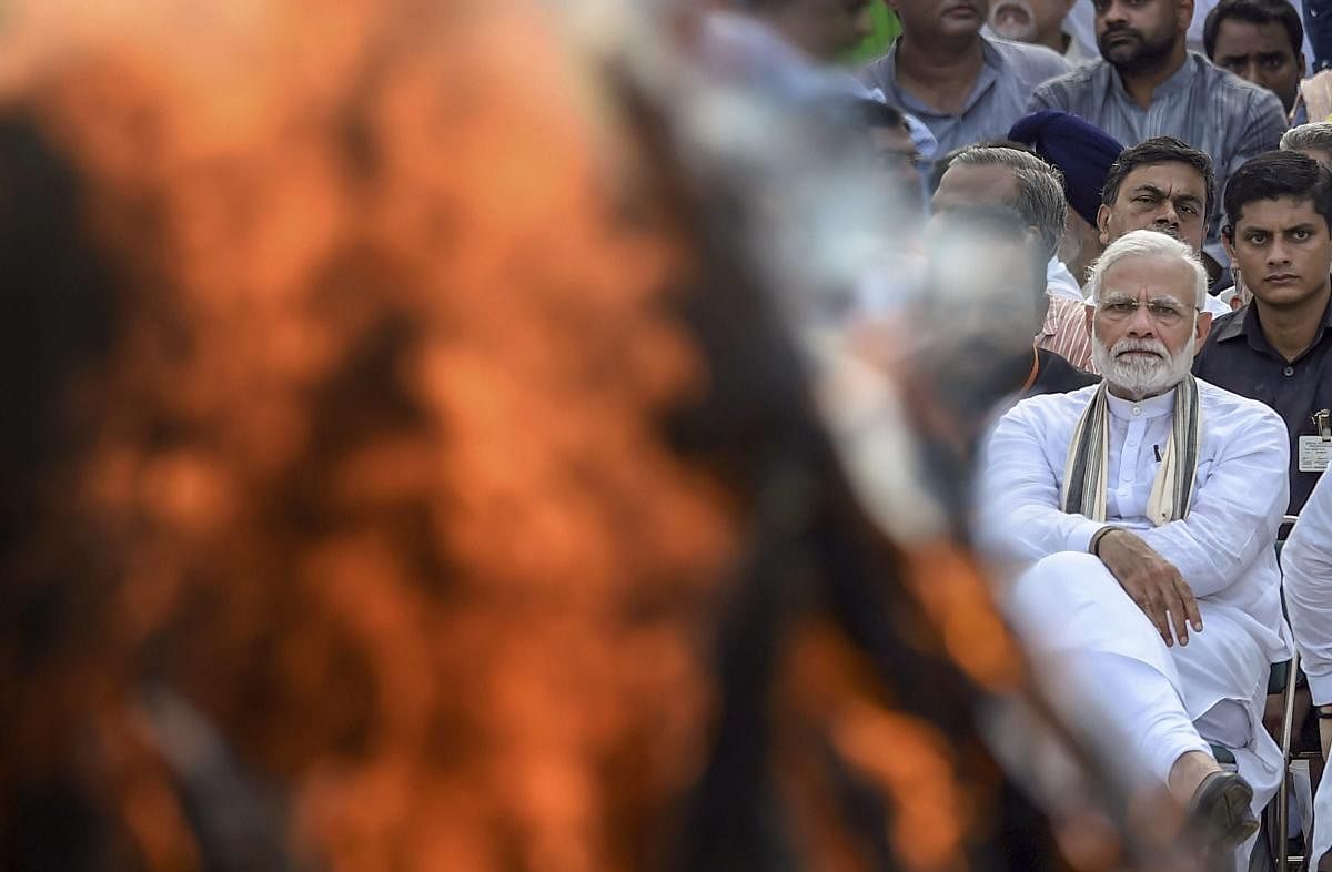 Prime Minister Narendra Modi during the cremation of former prime minister Atal Bihari Vajpayee with full state honour, at Rashtriya Smriti Sthal in New Delhi on August 17, 2018. PTI 
