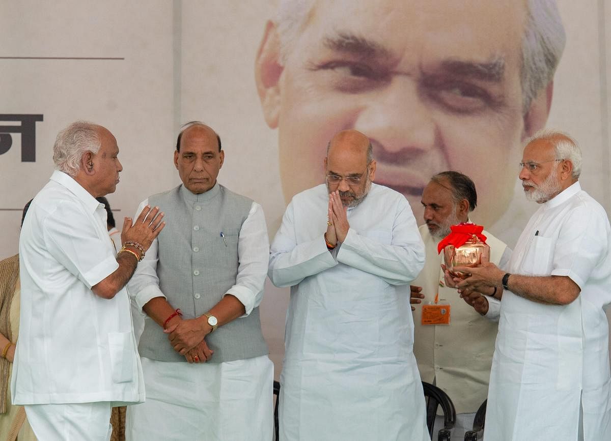 Prime Minister Narendra Modi hands over the ashes ('Asthi Kalash') of former prime minister Atal Bihari Vajpayee to Karnataka BJP President for immersion in his state, at the party headquarters in New Delhi on Wednesday. PTI