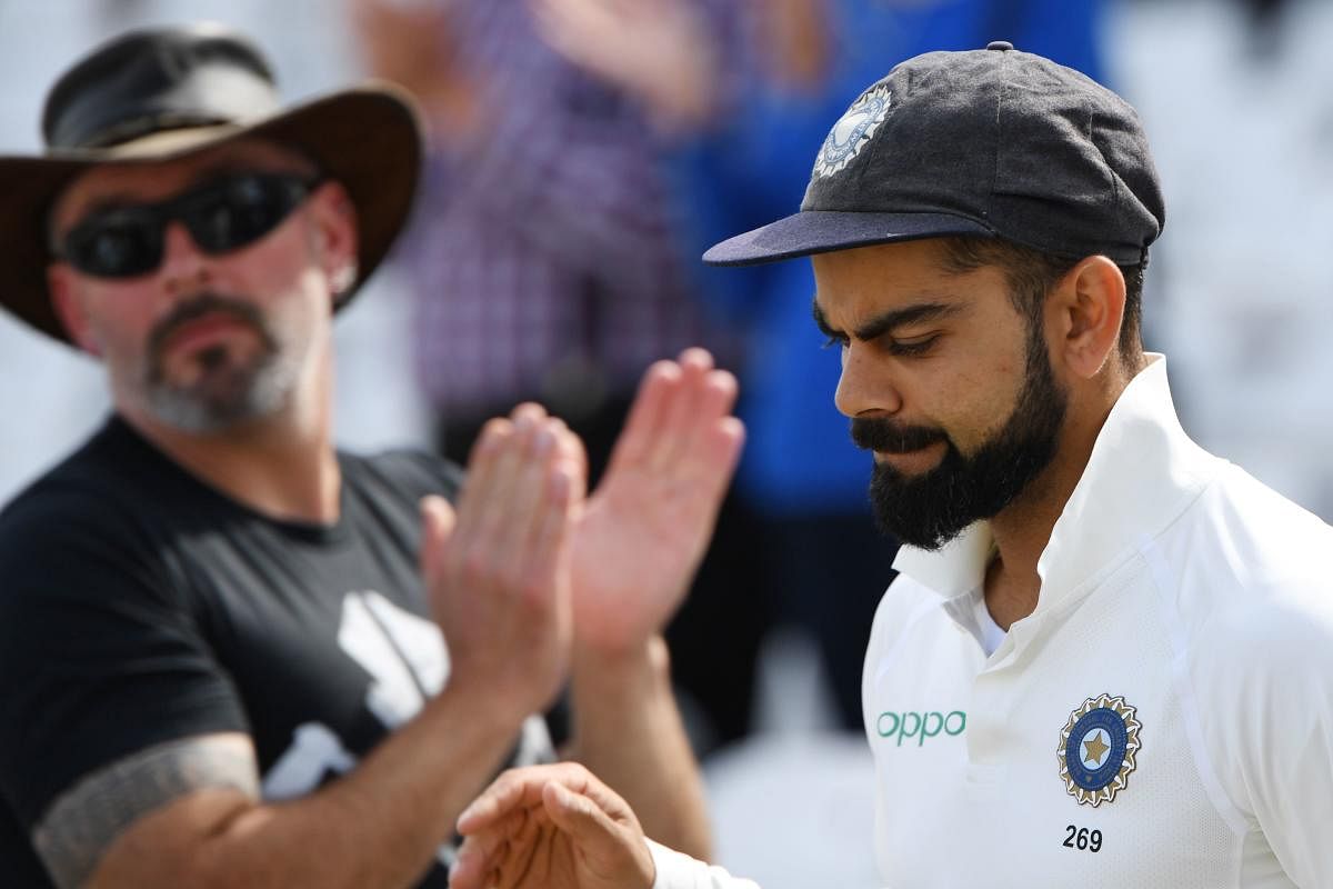 India's captain Virat Kohli is applauded as he leaves the field after winning the third Test cricket match between England and India at Trent Bridge in Nottingham, central England on Tuesday. AFP