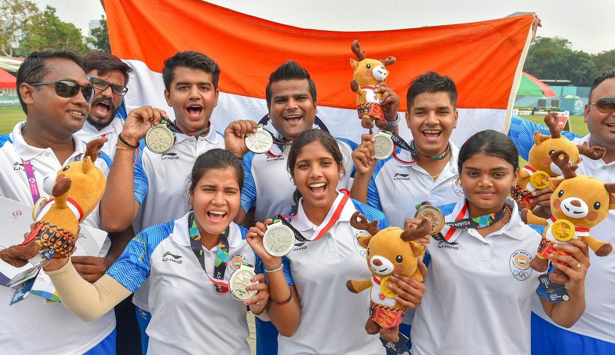 CHEERFUL Indian men's and women's archery team members celebrate with their silver medals in Jakarta on Tuesday. PTI