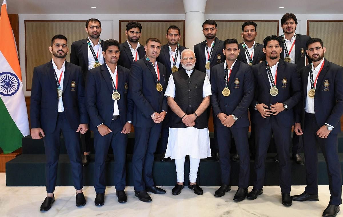 Indian men’s Kabaddi team that finished third in the Jakarta Asian Games pose for a photograph with Prime Minister Narendra Modi in New Delhi on Wednesday. PTI