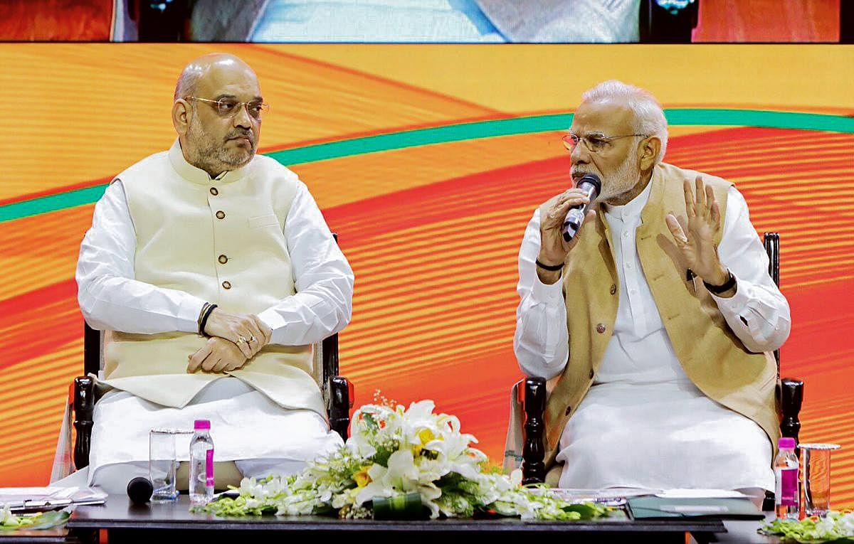 Prime Minister Narendra Modi and BJP president Amit Shah during BJP National Executive meeting, in New Delhi, Sunday. Twitter Photo via PTI