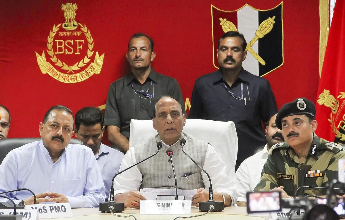 Home Minister Rajnath Singh (C) addresses the media as Mos for PMO Jitendra Singh (L) and DG BSF K K Sharma (R) look on, after the inauguration the first 'Smart Fence' pilot project along the Indo-Pak Border, in Jammu on Monday. (PTI Photo)