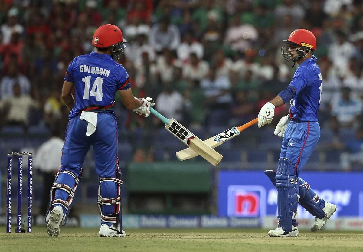 Afghanistan's Gulbadin Naib, left, and Rashid Khan cheer each other by touching the bats during the one-day international cricket match of Asia Cup between Bangladesh and Afghanistan in Abu Dhabi, United Arab Emirates, Thursday, Sept. 20, 2018. (AP/ PTI)