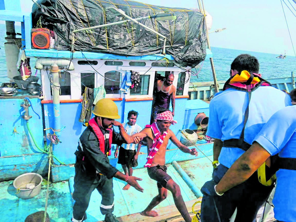 ICG personnel rescue fishermen.