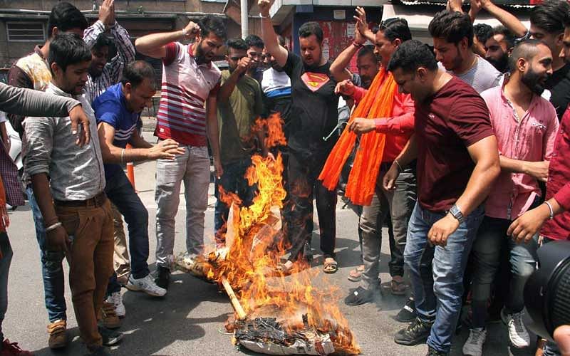 Bajrang Dal activists burn an effigy of Jammu and Kashmir Chief Minister Mehbooba Mufti during a protest demanding a CBI probe in the rape and murder of the 8-year-old Kathua girl, in Jammu on Saturday. PTI Photo
