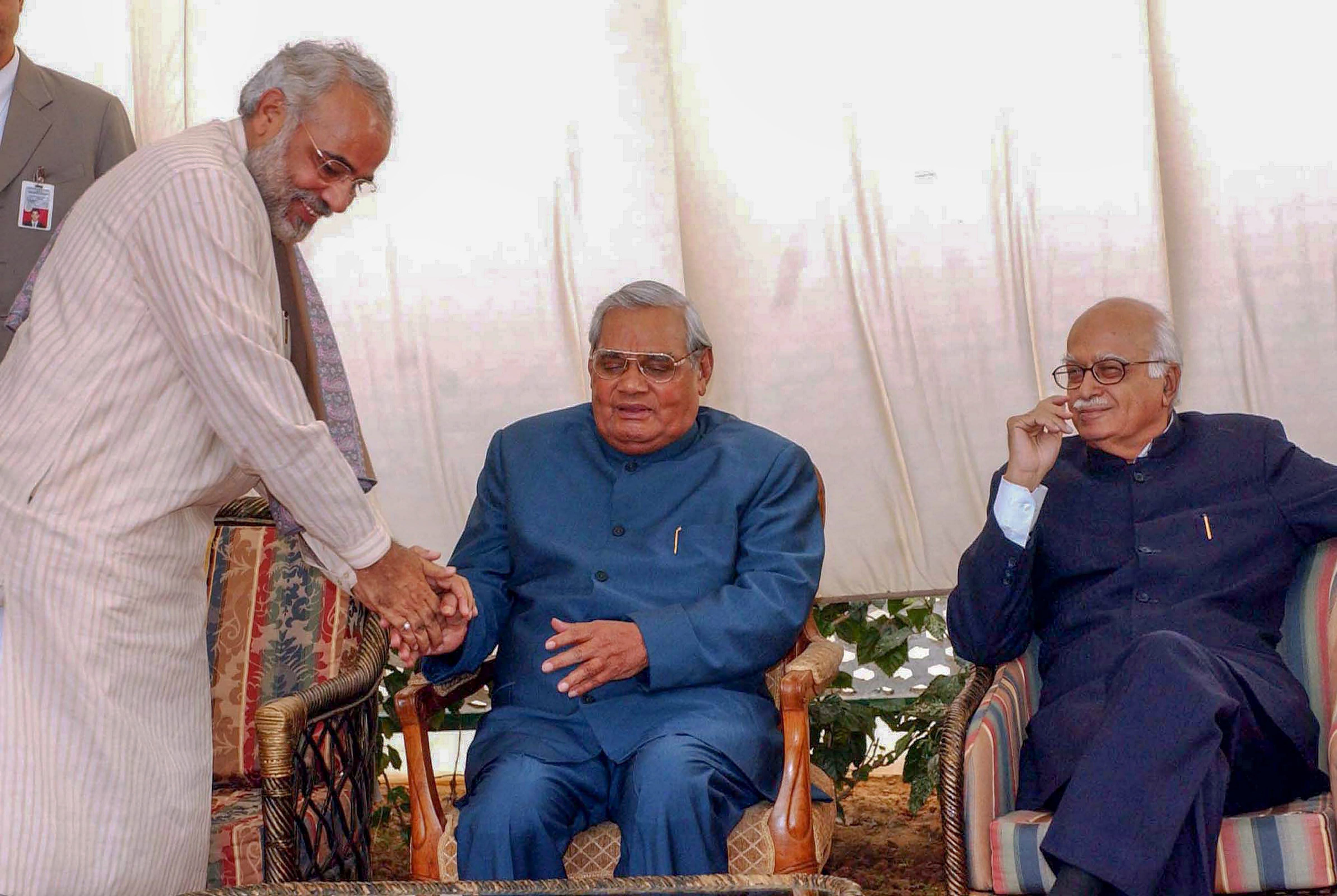In this December 09, 2003, file photo former prime minister Atal Bihari Vajpayee is seen with the then Gujarat CM Narendra Modi and BJP senior leader LK Advani at a lunch in New Delhi. PTI