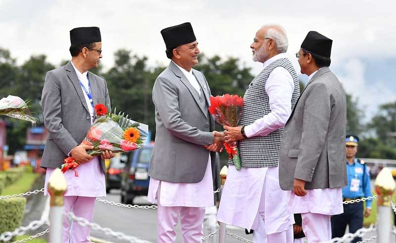 Ishwar Pokhrel, Deputy Prime Minister and Defence Minister of Nepal receives Prime Minister Narendra Modi on arrival at Kathmandu airport. (Photo credit: @MEAIndia/Twitter)