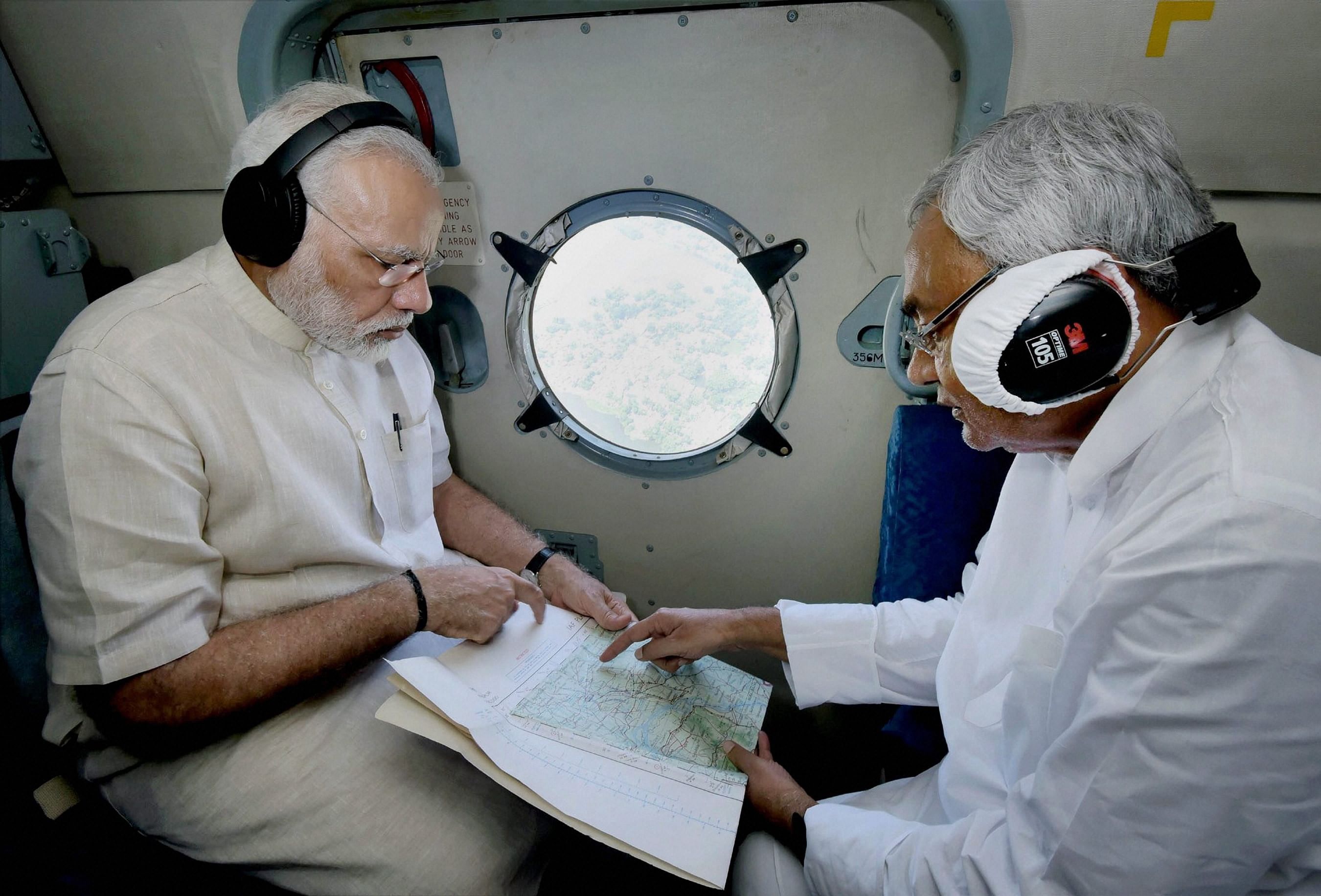 Prime Minister Narendra Modi with Chief Minister of Bihar Nitish Kumar conducting an aerial survey of flood affected areas, in Bihar. PTI file photo