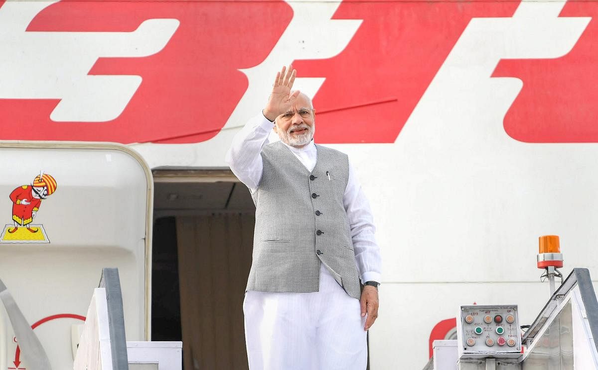 Prime Minister Narendra Modi gestures as he emplanes for Qingdao, China to attend the annual SCO Summit. PTI file photo.