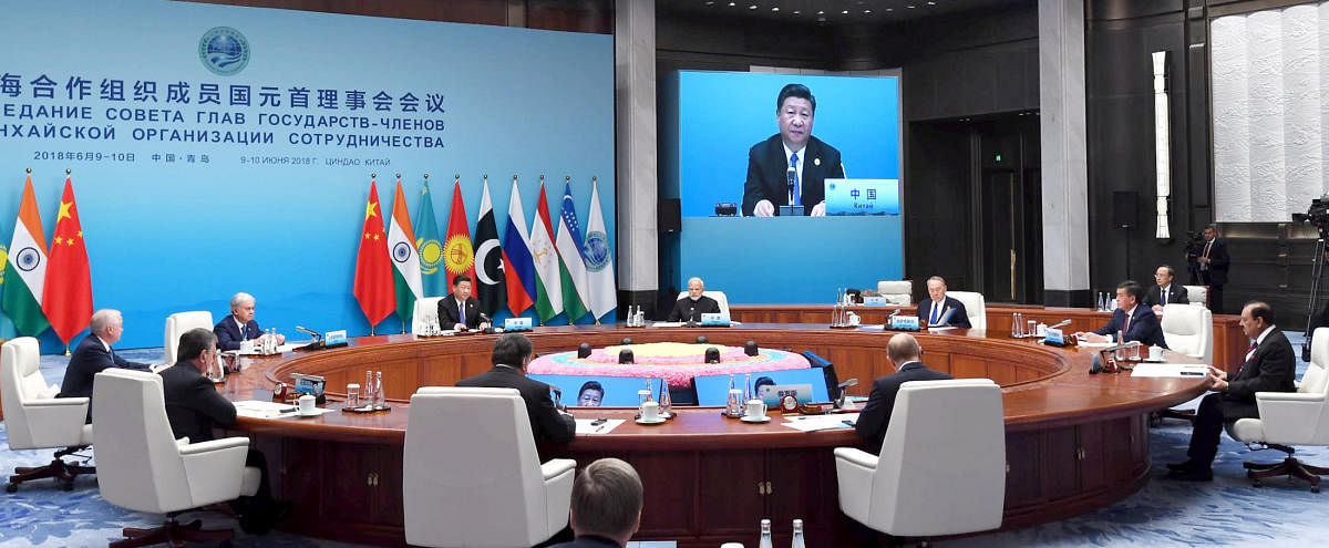 Narendra Modi and Chinese President Xi Jinping are seen along with other heads of state at a meeting at the Shanghai Cooperation Organization (SCO) summit in Qingdao. Reuters