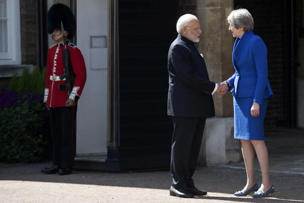 Britain's Prime Minister Theresa May greets Indian Prime Minister Narendra Modi at the official welcome ceremony for the Commonwealth Heads of Government Meeting at Friary Court in St James's Palace, London, Thursday April 19, 2018. AP/PTI