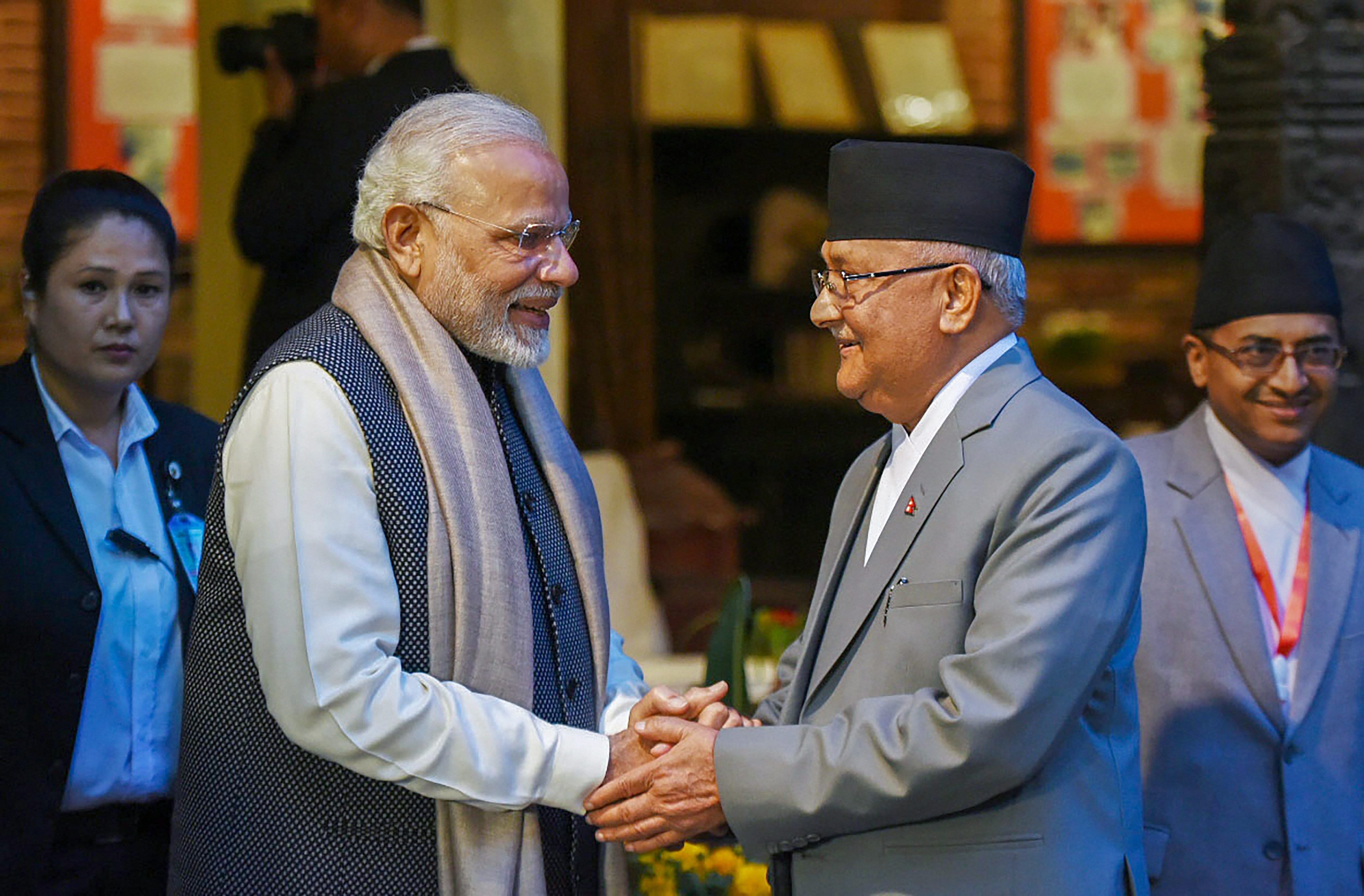 Prime Minister Narendra Modi shakes hands with his Nepali counterpart KP Sharma Oli ahead of delegation level talks in Kathmandu on Friday. PTI