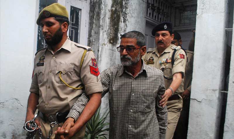 Sanji Ram arrives for a court appearance after he was arrested in connection with the rape and murder of an eight-year-old girl in Kathua, south of Jammu, April 16, 2018. REUTERS/Stringer