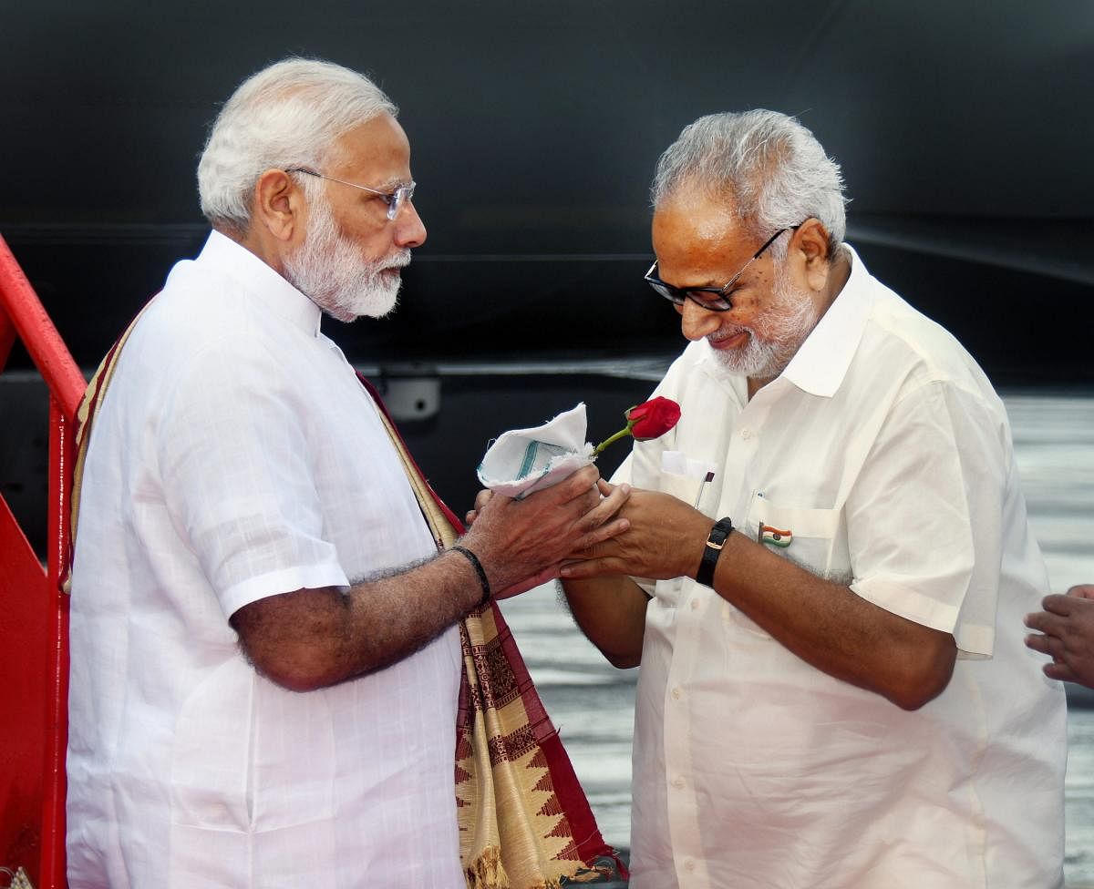 Prime Minister Narendra Modi is received by Governor Ganeshi Lal on his arrival at the Bhubaneswar airport, Saturday, Sep 22, 2018. (PTI Photo)