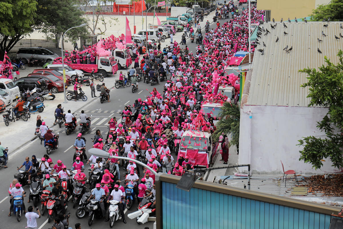 Supporters of the Maldivian President Abdulla Yameen ride on their bikes during the final campaign march rally ahead of their presidential election in Male. Reuters.