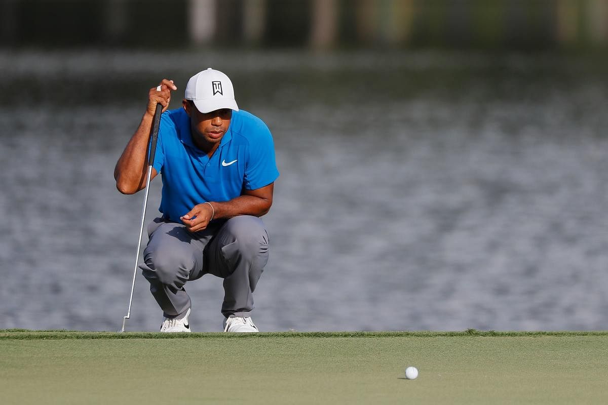 BACK IN THE GROOVE Tiger Woods lines up a putt on the 15th green during the third round of the Tour Championship in Atlanta on Saturday. AFP