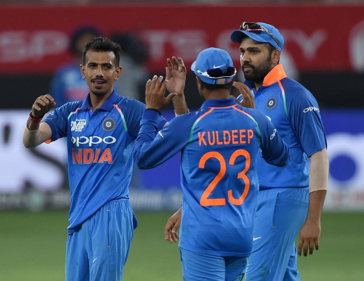 GOT HIM: India's Yuzvendra Chahal (left) celebrates with team-mates after dismissing Pakistan's Asif Ali in Dubai on Sunday. AFP