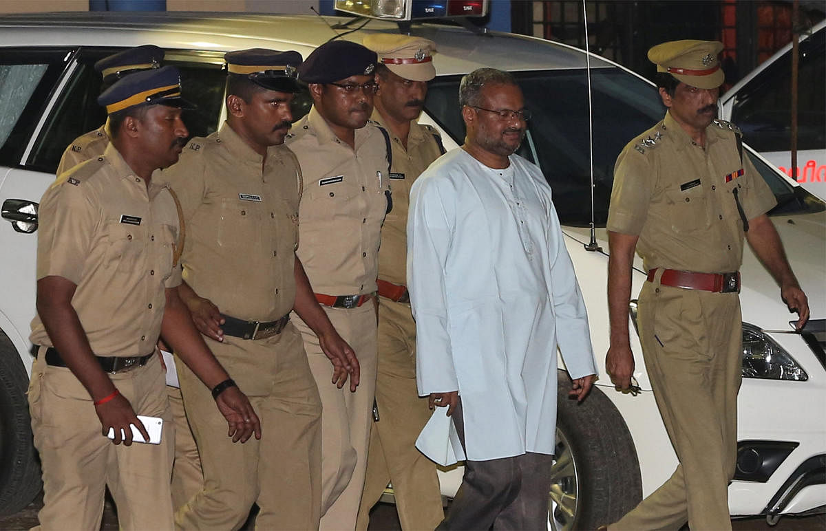  Franco Mulakkal (2nd R), accused of raping a nun, is escorted by police outside a crime branch office on the outskirts of Kochi in the southern state of Kerala. Reuters file photo.