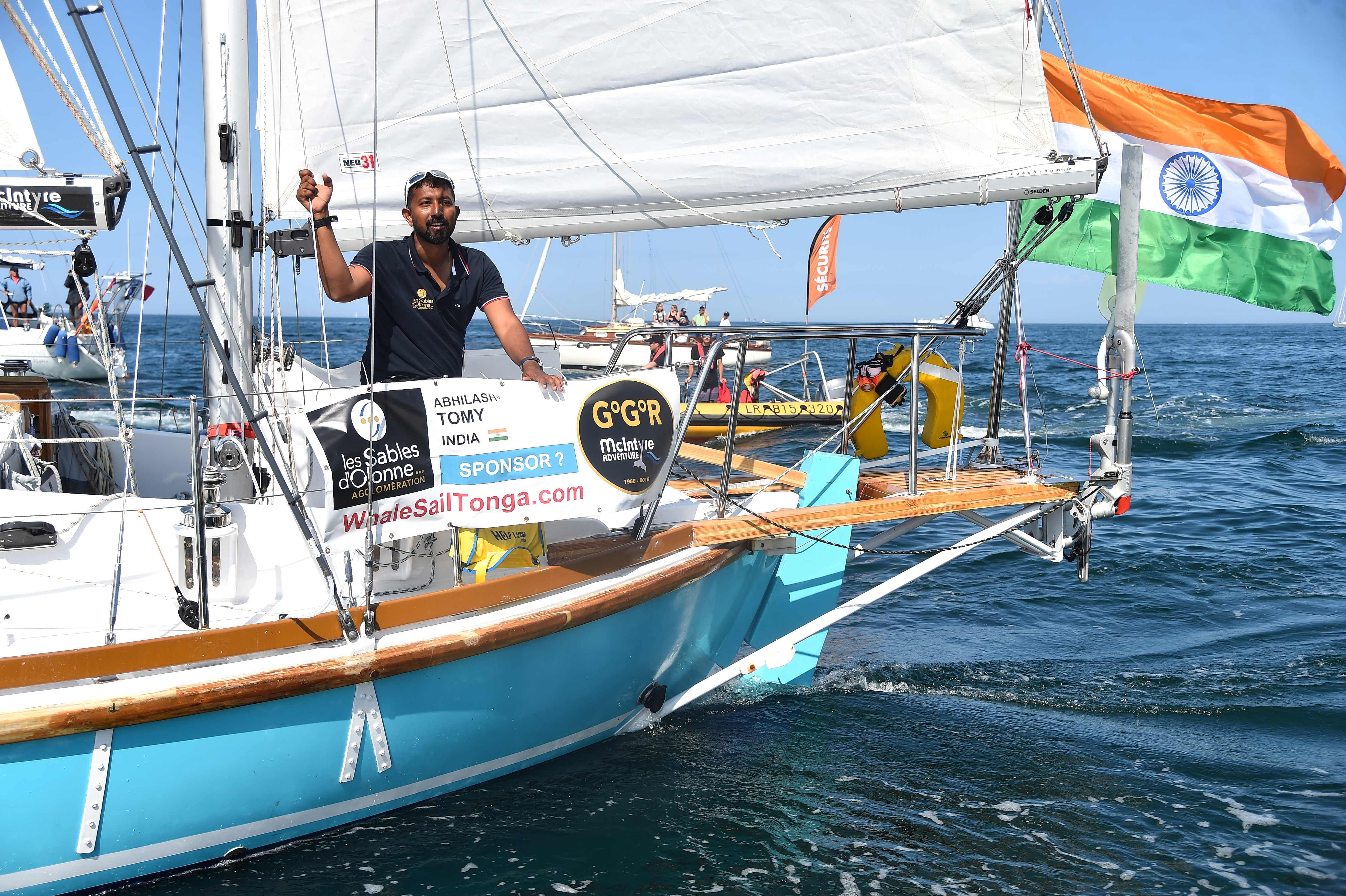 Navy Commander Abhilash Tomy gestures from his boat "Thuriya" as he sets off from Les Sables d'Olonne Harbour on July 1, 2018, at the start of the solo around-the-world "Golden Globe Race" ocean race. (AFP)