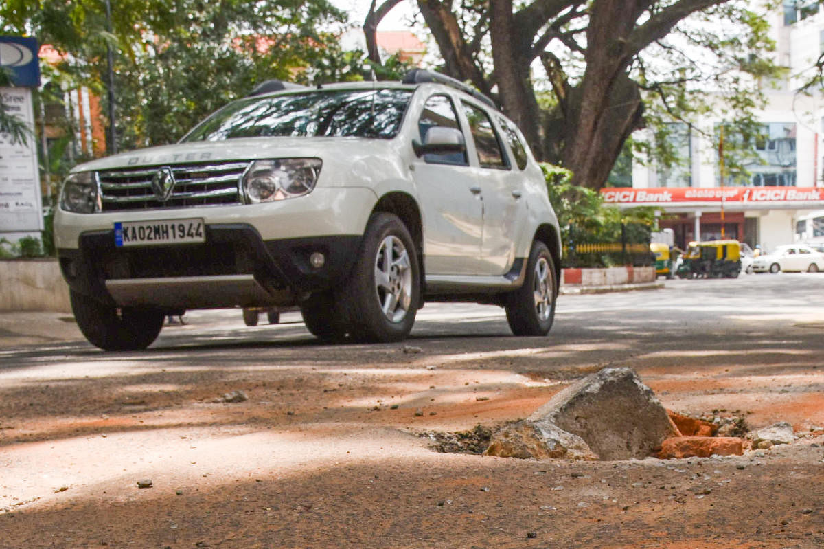 Pothole seen in front of Global Tech Park, Cornwell cross and O Shaughnessy road junction, Langford town in Bengaluru on Sunday. Photo by S K Dinesh