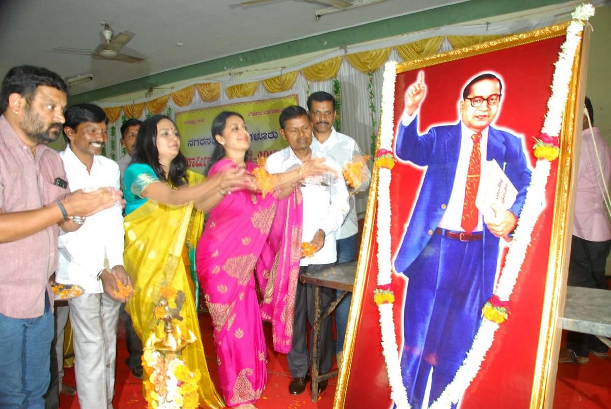 CMC President Shilpa Rajashekar pays floral tributes to the portrait of Dr B R Ambedkar during the Civic Workers’ Day celebrations in Chikkamagaluru on Monday. 