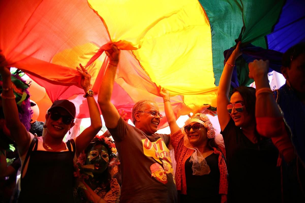 Members of Nepal's Lesbian, Gay, Bisexual and Transgender (LGBT) community take part in a gay pride parade in Kathmandu on August 27, 2018. - Each year Nepal's LGBT community take to the street on Gai Jatra, a Hindu and Buddhist festival associated with c