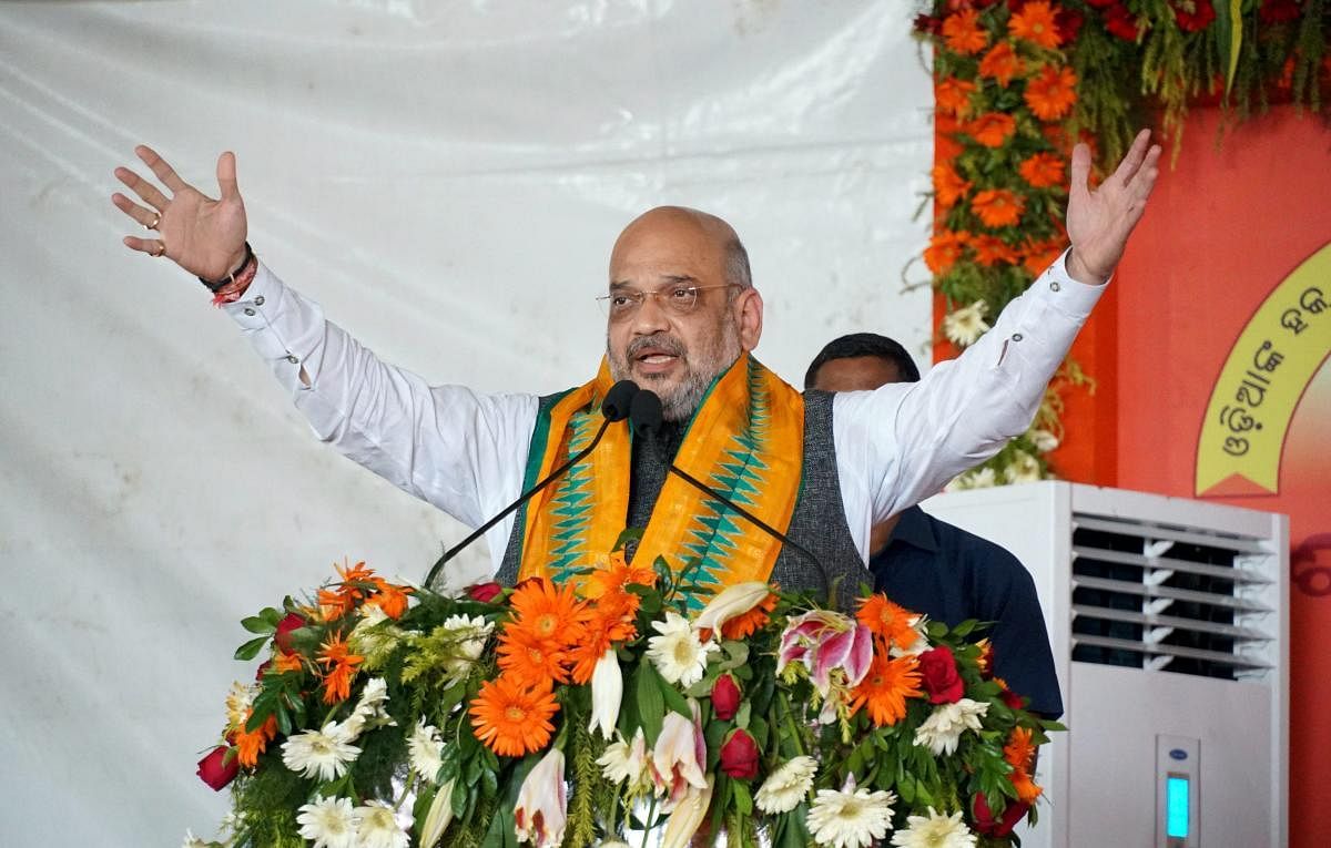 BJP chief Amit Shah addresses a gathering during a three-day national executive meet of the party's women's wing in Puri on Monday. PTI