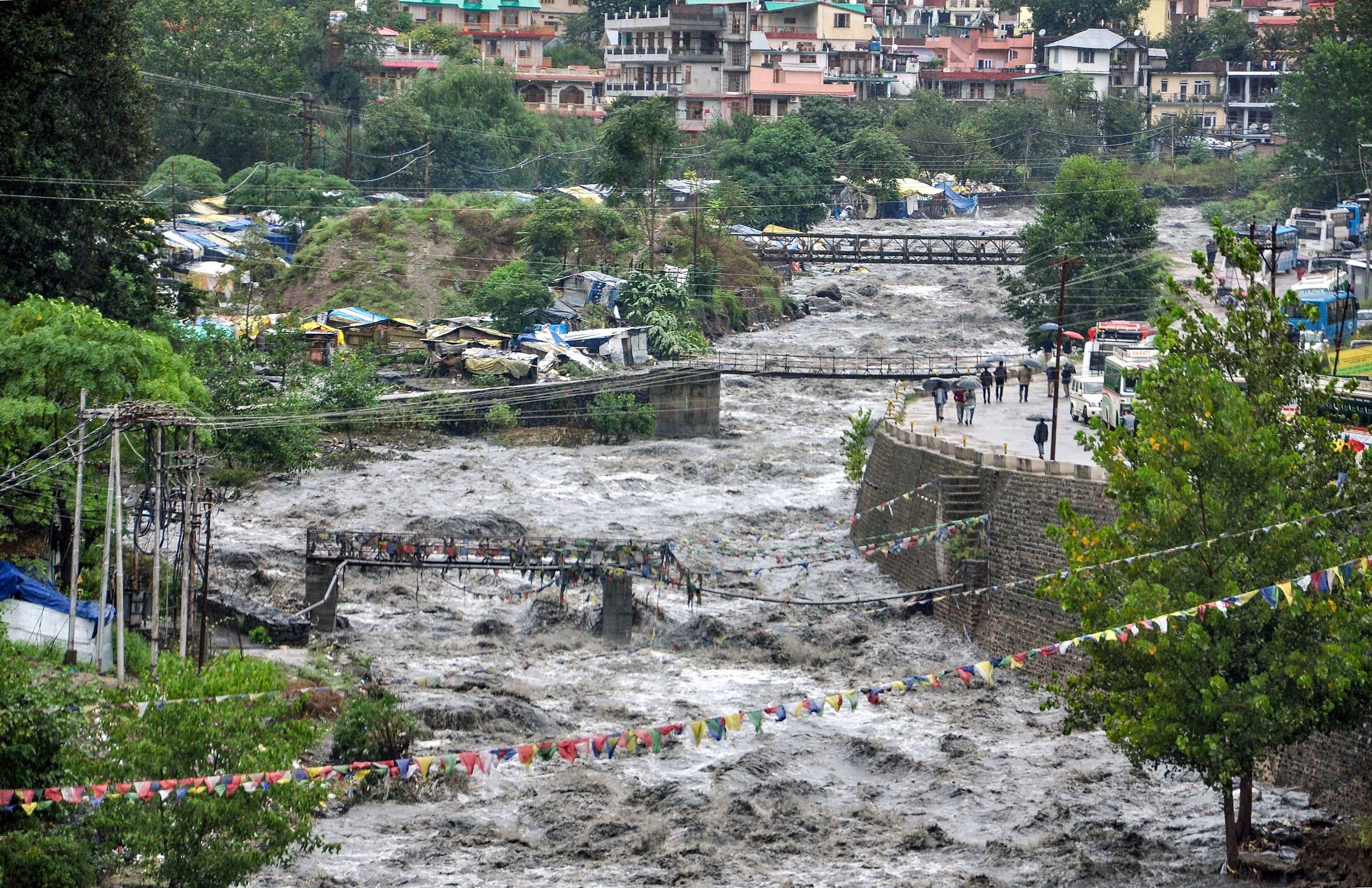 A swollen Beas river flows after heavy rains in the region, in Kullu district, Monday. PTI