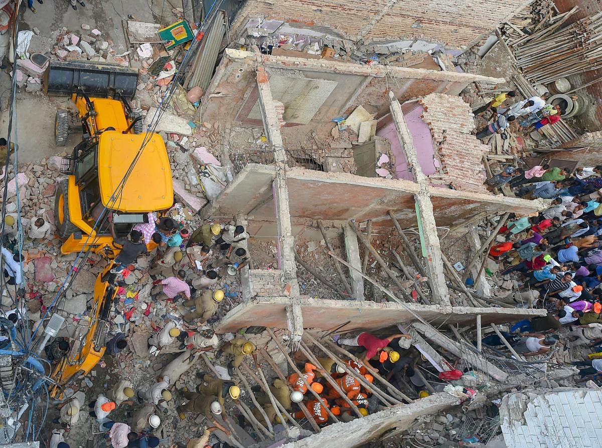 Rescue workers carry out the operation after a three-storey building collapsed at Ashok Vihar in northwest Delhi on Wednesday. (PTI file photo)