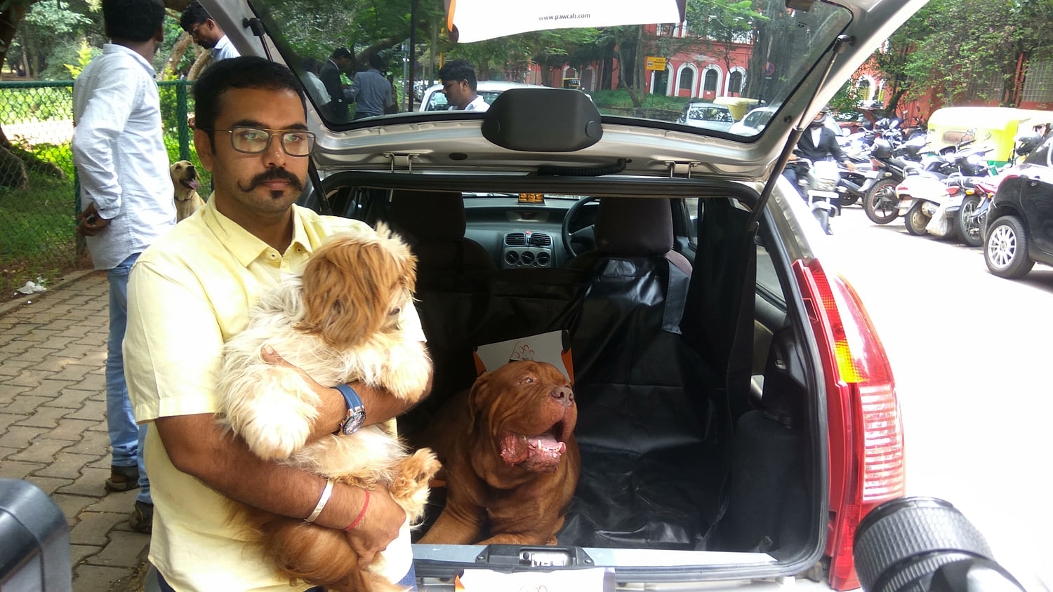 Amrut Sridhar Hiranya, founder of Paw Cab, an app-based cab service for transporting pets in Bengaluru on Wednesday. His partner Ravi Srivatsa is also seen. DH photo/Janardhan B K