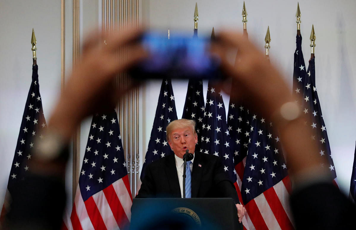 A reporter uses his mobile phone to record U.S. President Donald Trump at a news conference on the sidelines of the 73rd session of the United Nations General Assembly in New York, U.S., September 26, 2018. Reuters