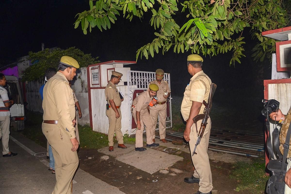Police personnel gather near BJP MLA Sangeet Som's residence after few unknown assailants opened fire at the house in Meerut. (PTI photo)
