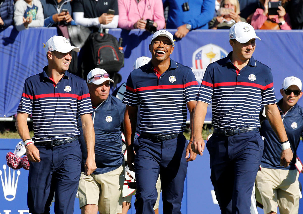 Team USA's (from left) Justin Thomas, Tiger Woods and Jordan Spieth share a joke during a practice session at the Le Golf National. REUTERS