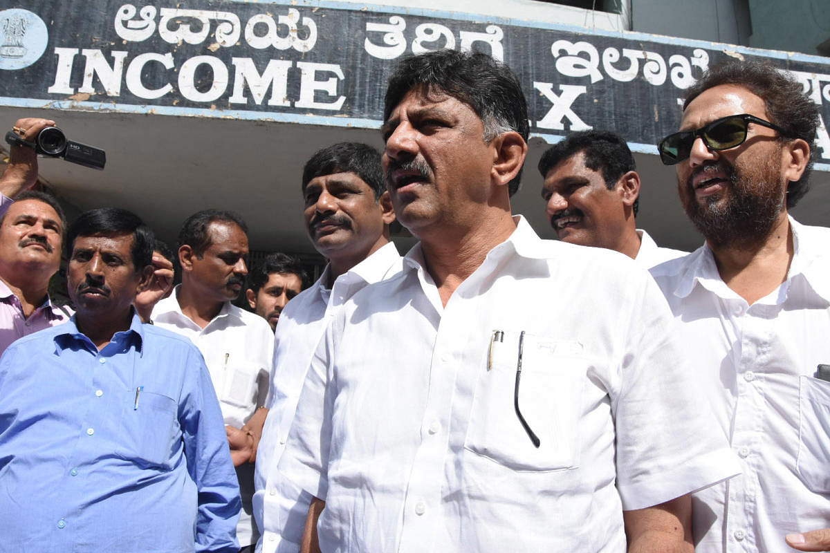 Minister D K Shivakumar and his brother and parliamentarian D K Suresh (second from left) walk out of the Income Tax office after questioning by officials, in Bengaluru. (DH File Pic)