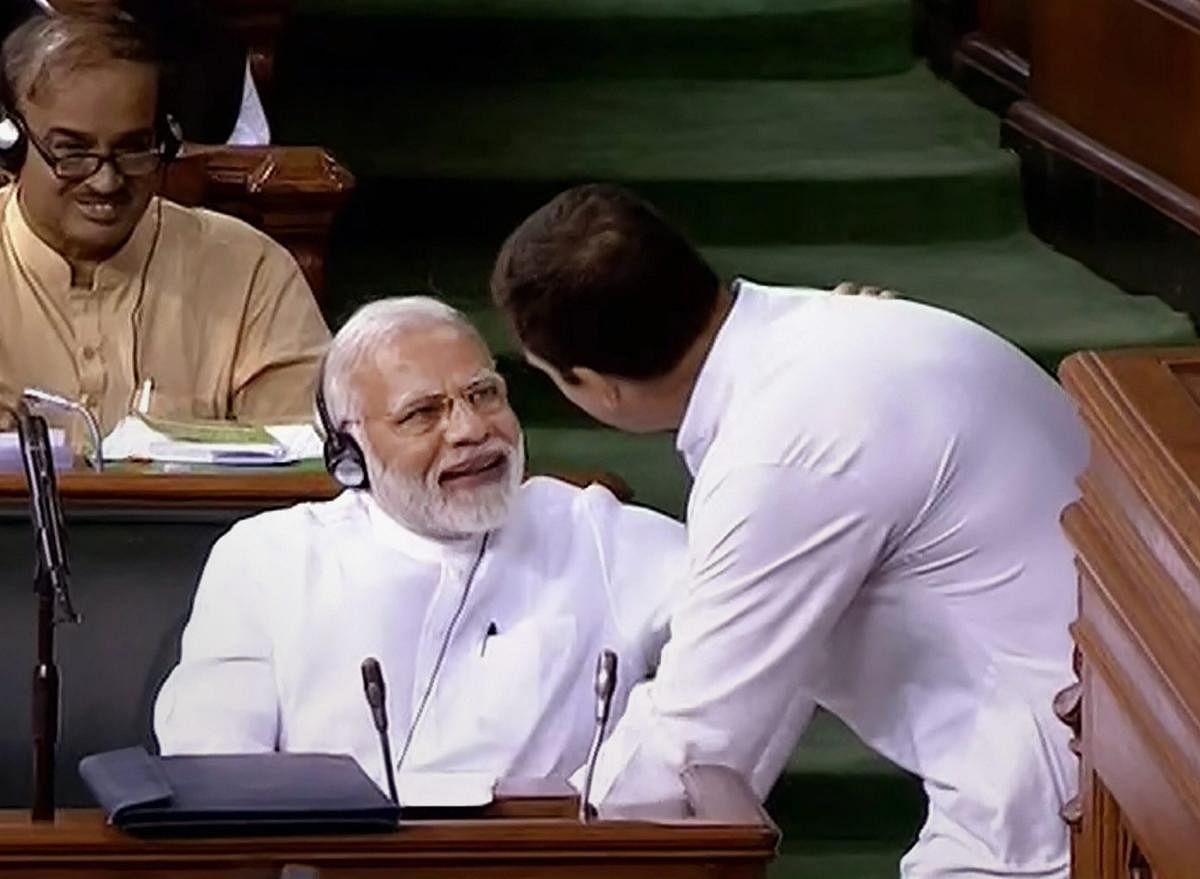 Congress President Rahul Gandhi hugs Prime Minister Narendra Modi after his speech in the Lok Sabha on 'no-confidence motion' during the Monsoon Session of Parliament, in New Delhi on Friday, July 20, 2018. (PTI Photo)