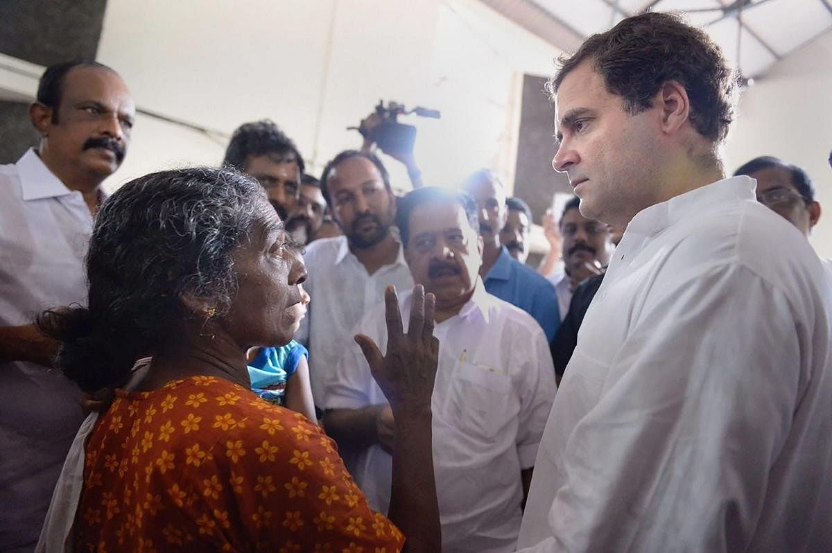 Congress President Rahul Gandhi interacts with the flood-affected people at a relief camp in Chengannur, Kerala on Tuesday, August 28, 2018. (PTI Photo)