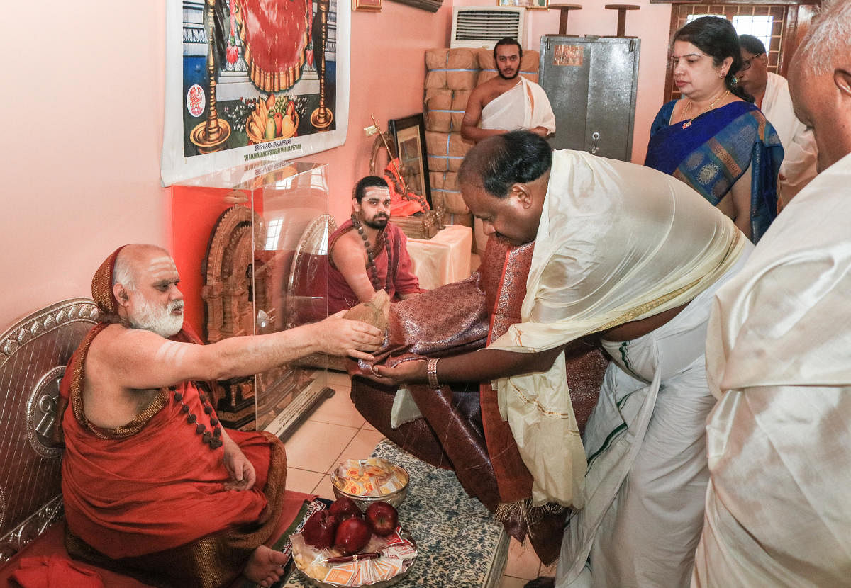 Seer Bharathitheertha Swami blesses Chief Minister HD Kumaraswamy at Sharadamba temple in Sringeri onSaturday. Junior pontiff Vidushekhara Bharathi, AnithaKumaraswamy are seen.