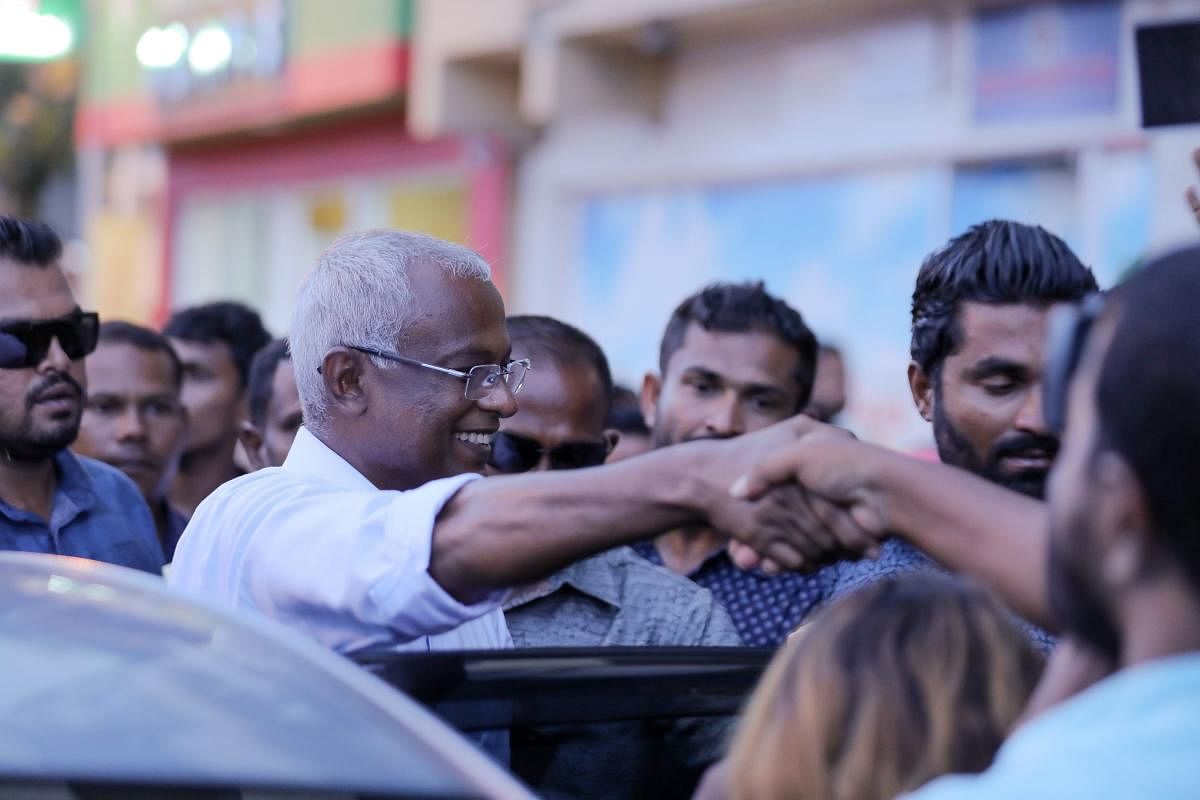 Ibrahim Mohamed Solih (centre) greets a crowd after winning Maldives' presidential election in Male on September 24, 2018. AFP