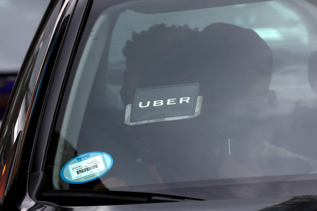 An Uber logo is seen on a car as it car drives through Times Square in New York City on July 27, 2018. Reuters