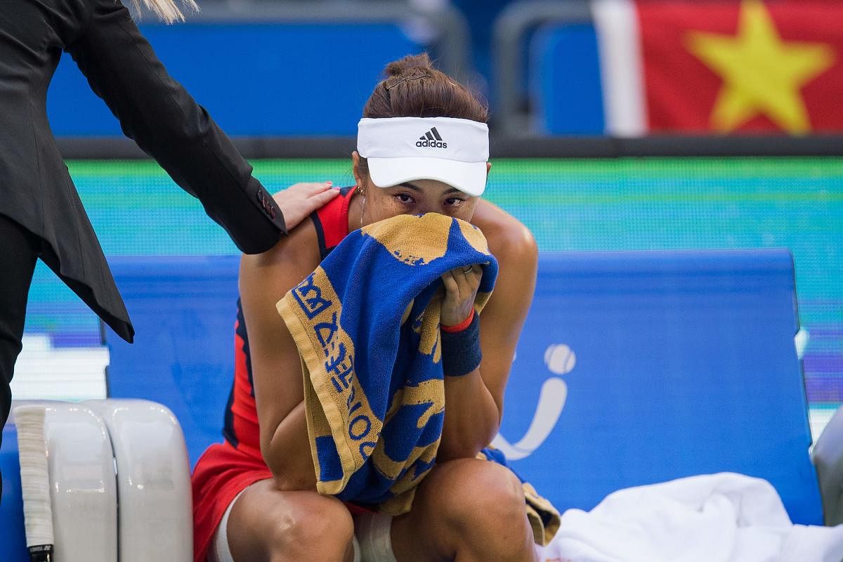 China's Wang Qiang can't control her tears after being forced to pull out of her home Wuhan Open semifinal against Anett Kontaveit on Friday. AFP