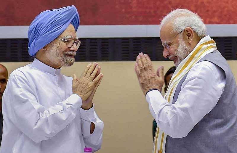 Former prime minister Manmohan Singh greets his successor Narendra Modi. (PTI File Photo)