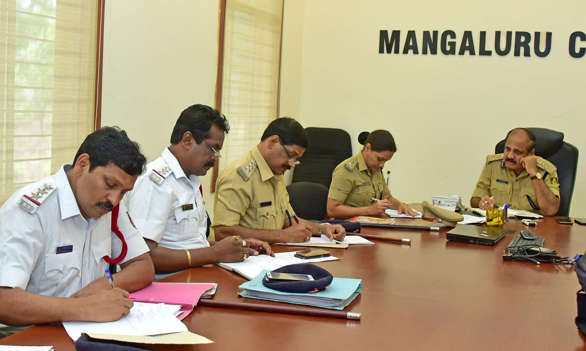 City Police Commissioner T R Suresh, DCP (Crime and Traffic) Uma Prashanth and other officials listen to the grievances of public during the monthly phone-in programme organised by Mangaluru Police Commissionerate on Friday.