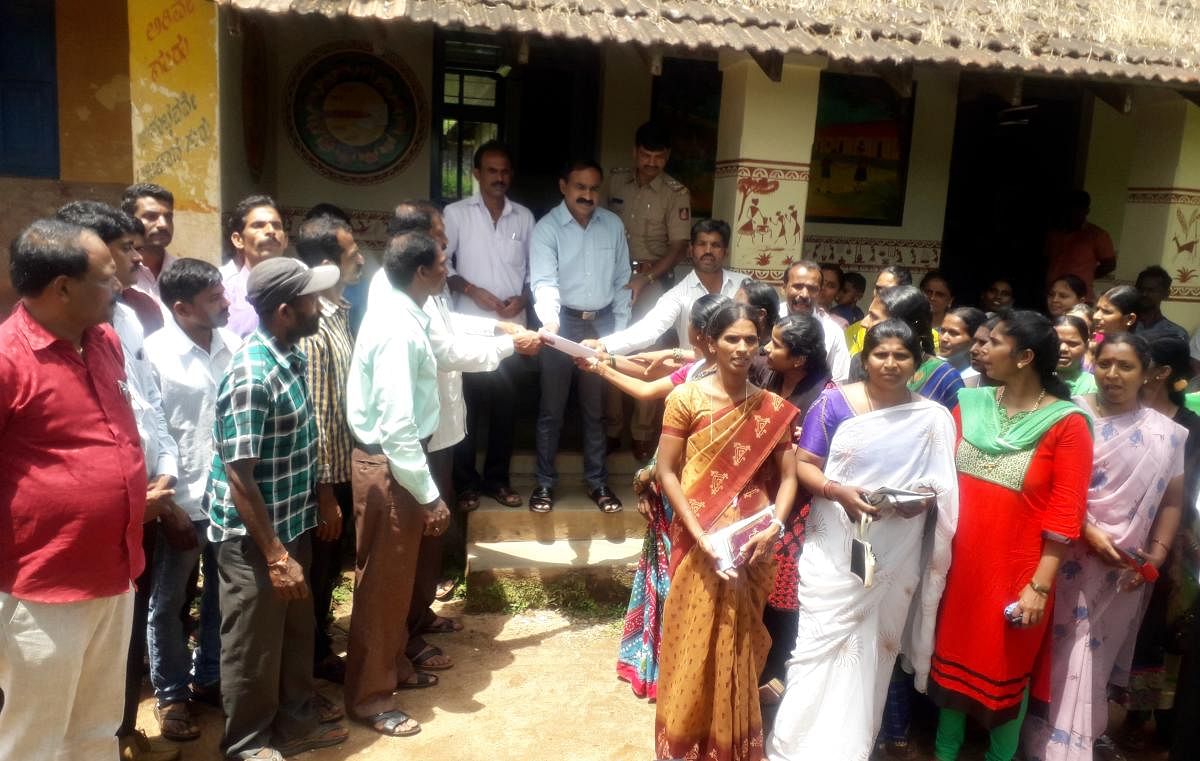 SDMC members and parents stage a protest outside BEO's office in Koppa against the suspension of Niluvagilu Government Primary School headmaster A E Ashok.