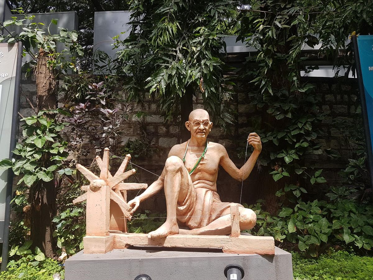 A sculpture of Gandhi and his charkha in Gandhi Bhavan.