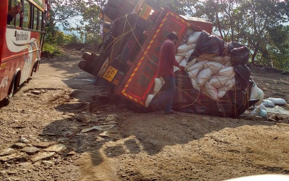 The lorry which toppled on Charmadi Ghat stretch.