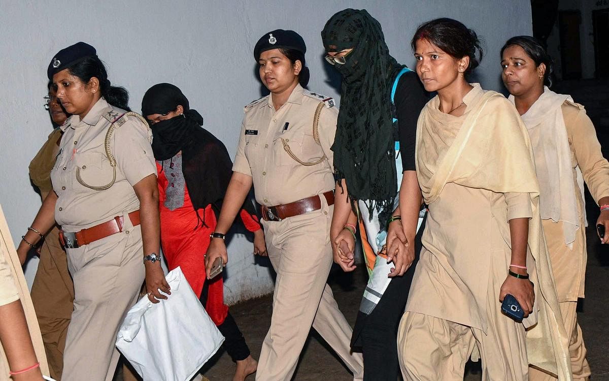 Police personnel produce Manisha, a secretary at an NGO which ran the shelter home for mentally-challenged women where two inmates died under mysterious circumstances, at a civil court, in Patna on Monday. PTI