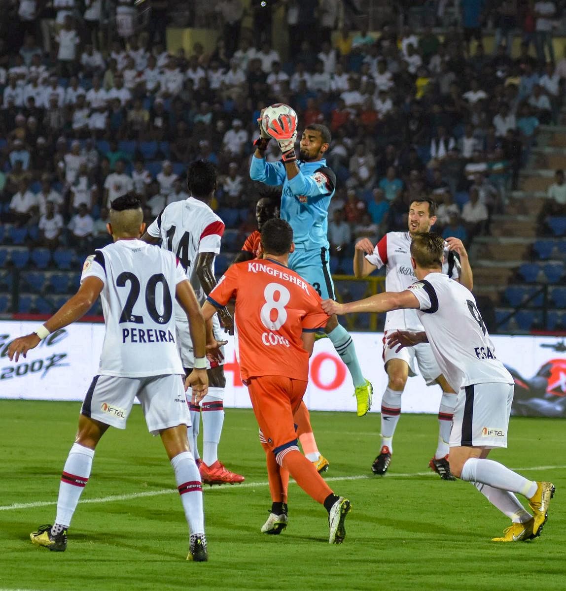ACTION-PACKED: NorthEast United FC goalkeeper TP Rehenesh collects the ball during their match against FC Goa during their ISL match in Guwahati on Monday. (PTI Photo)