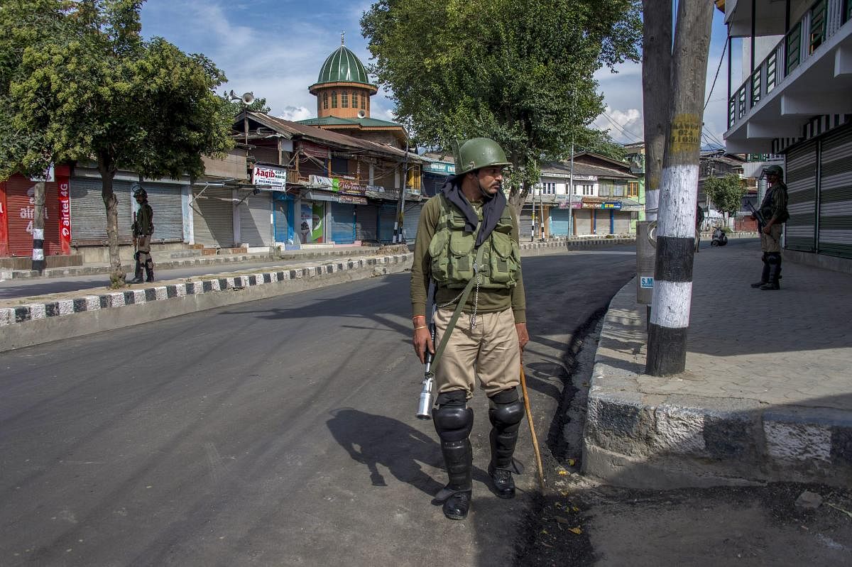 A security person stands guard during restrictions and strike call given by separatist leaders against, in Srinagar. (PTI File Photo)