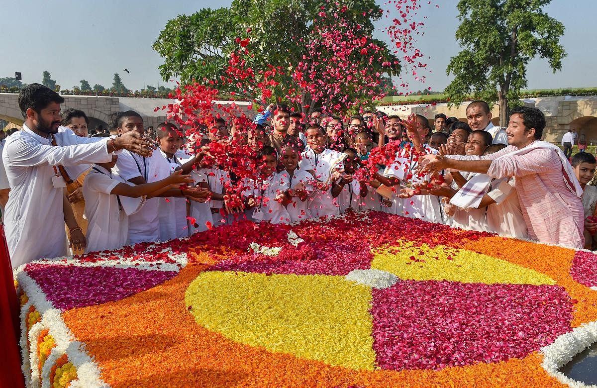 Students pay floral tribute to Mahatma Gandhi on the occasion of his 150th birth anniversary, at Rajghat in New Delhi on Tuesday. (PTI)